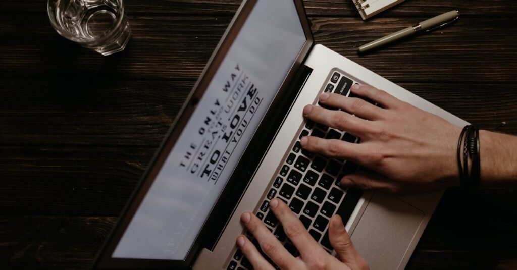 Hands on a laptop with an inspirational quote displayed on the screen, shot from above.